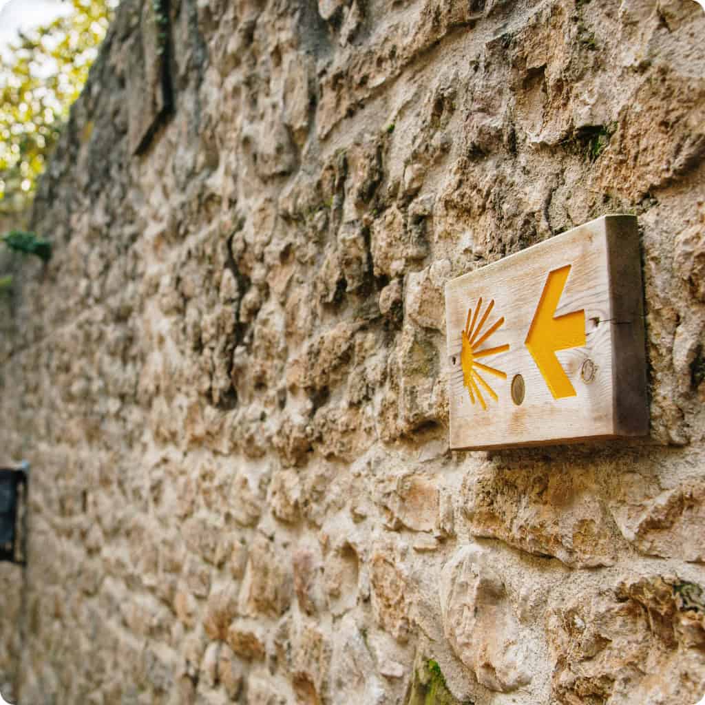 Yellow arrow signage camino de santiago