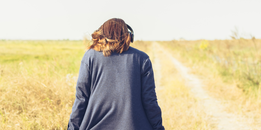 Woman walking the Camino wearing headphones