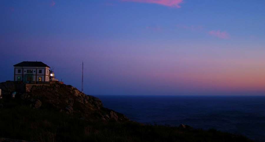 a picture of a lighthouse during a sunset on the Camino