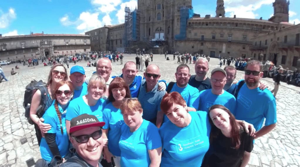 Charity group posing in front of the Cathedral in Santiago