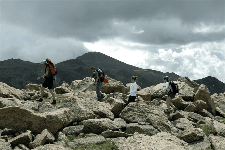 Walkers walking in rocky terrin
