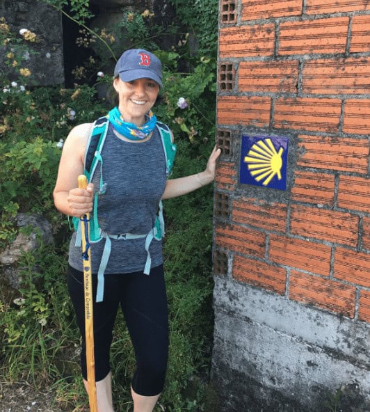 Camino Experts Katherine posing with the scallop shell on the camino