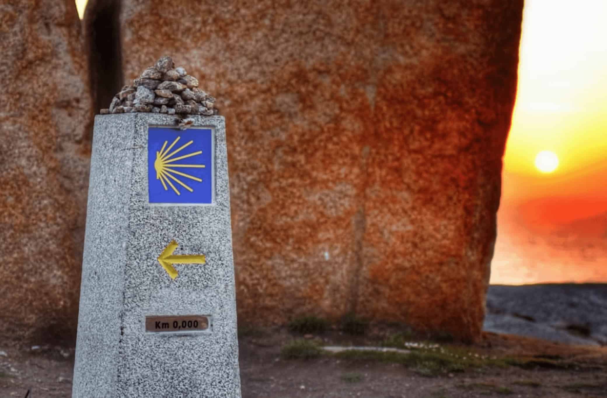 Camino Marker at Zero Km with sunset in the background