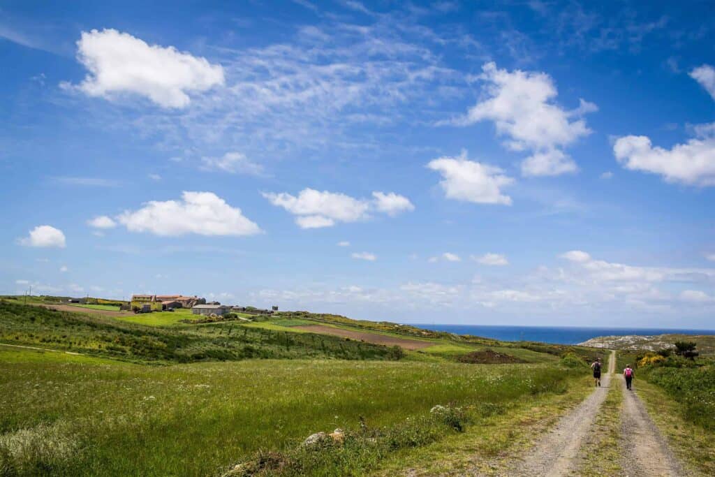 Pilgrim walking camino finisterra - end of the world toward sea