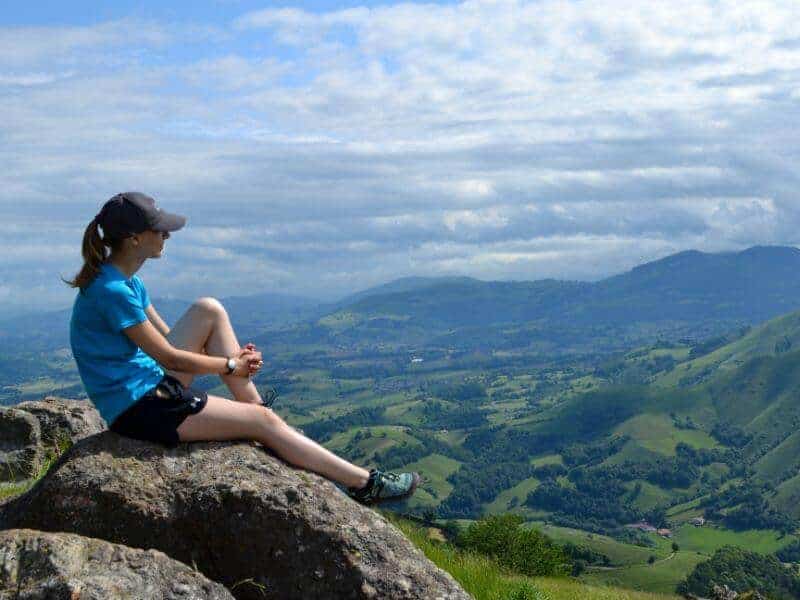 pilgrim sitting on the mountain on the Camino