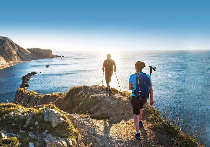 Camino Daypacks pilgrims walking on the coast