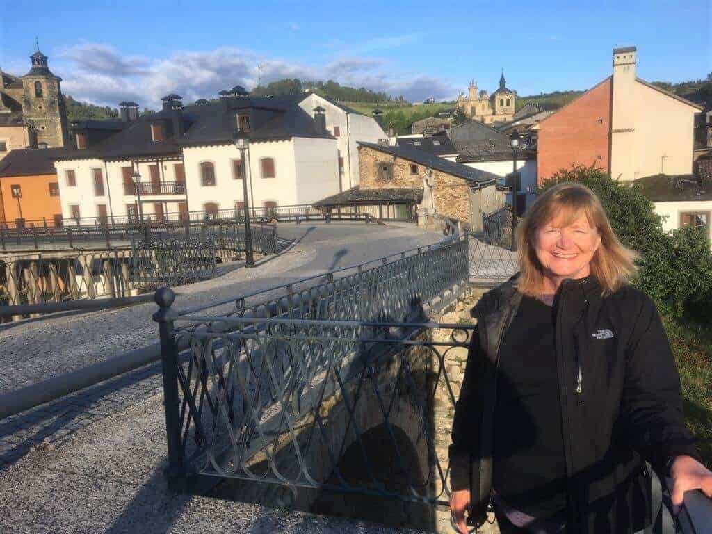 a pilgrim standing in front of a town