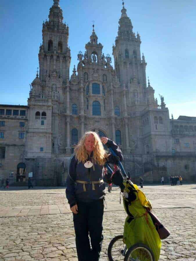 a picture of a pilgrim standing in front of a cathedral
