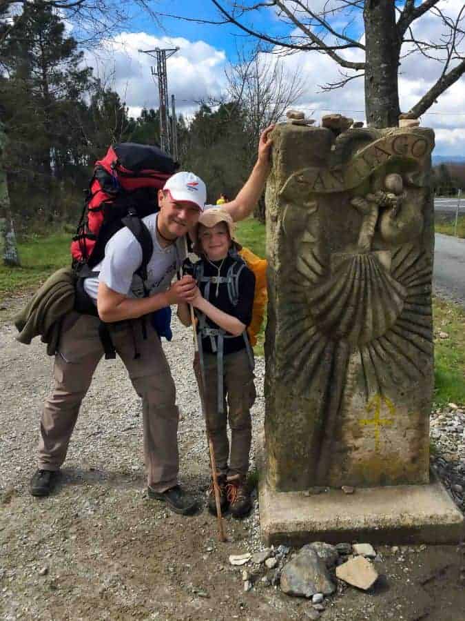 a picture of 2 pilgrims standing next to a religious structure