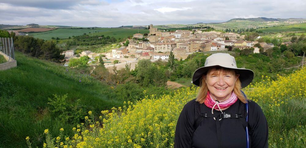 a pilgrim standing in front of a town