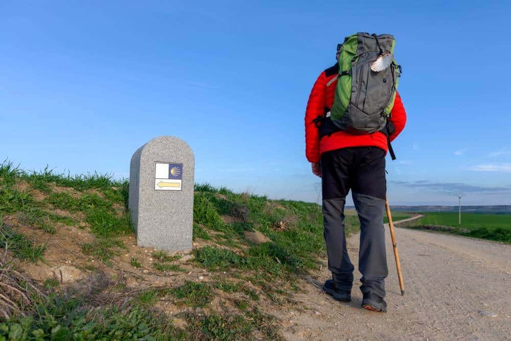 a picture of a pilgrim walking through a valley