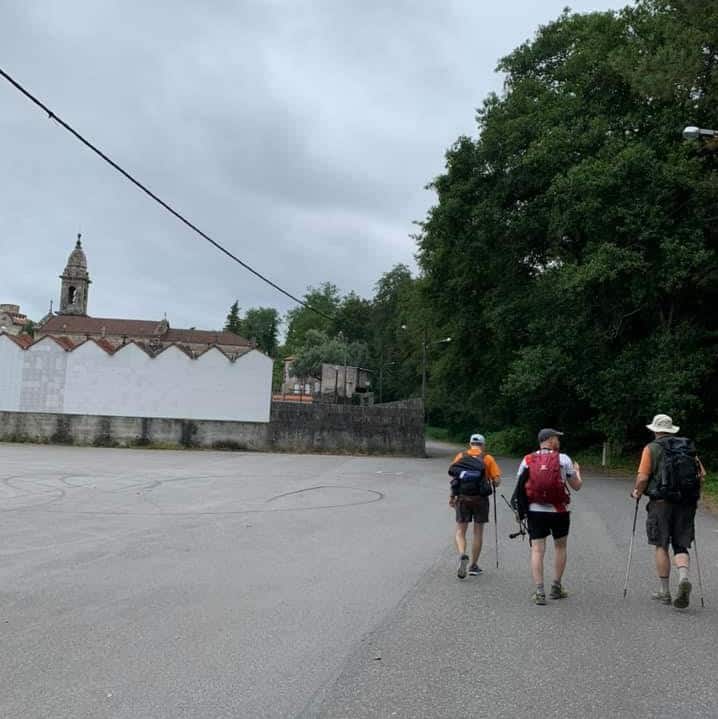 a picture of a groups of pilgrims walking to the forest