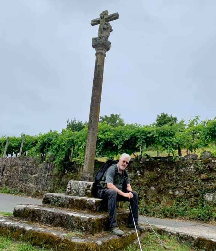 a picture of a pilgrim sitting in front of a religious structure