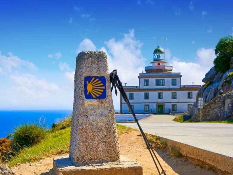 Camino malker with finisterre lighthouse