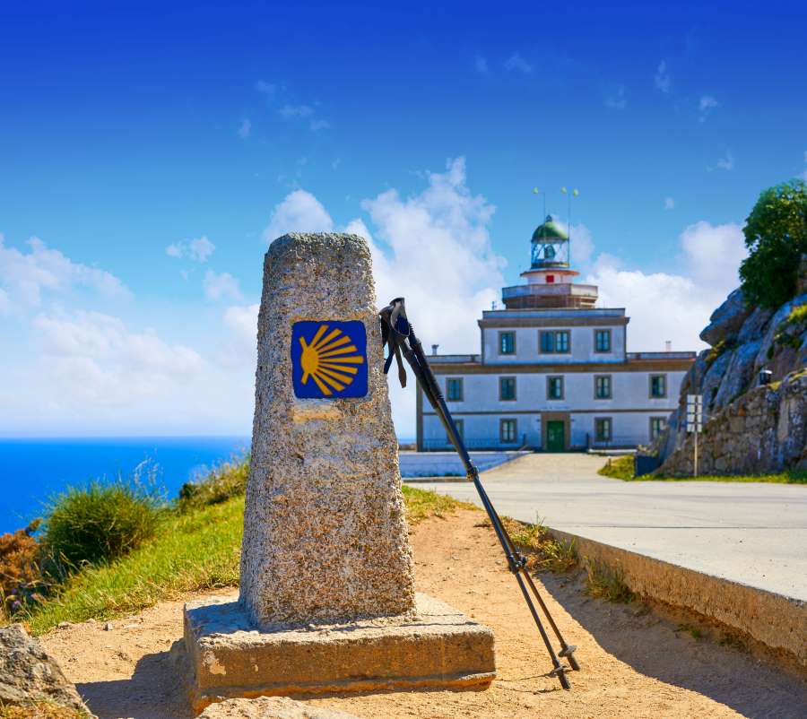 a picture of a milestone in front of the lighthouse