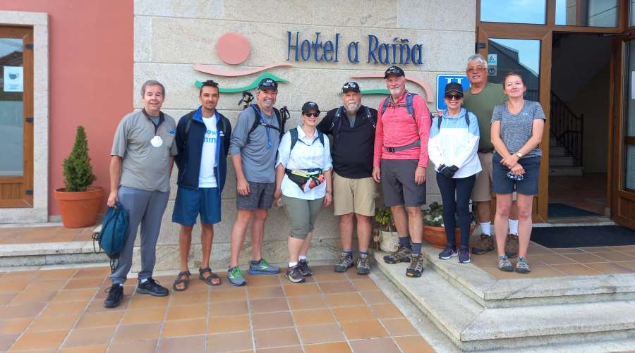 a picture of a group of pilgrims standing in front of their accomodation on the Camino
