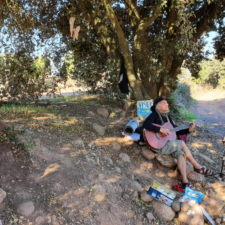 Man singing below tree on camino frances