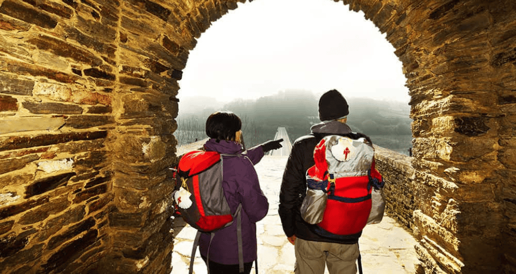 Romantic couple looking at path on Camino