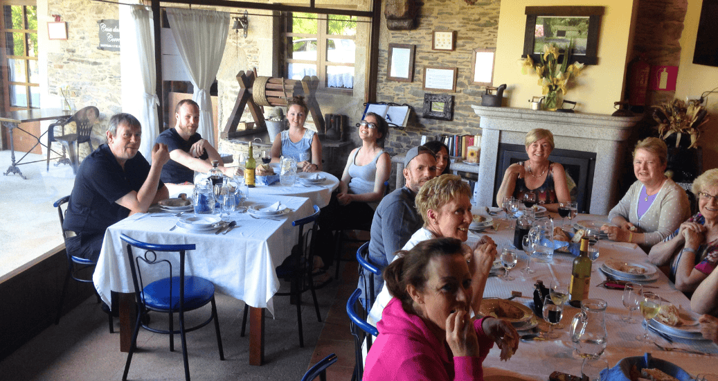 Pilgrim guided group sitting in restaurant