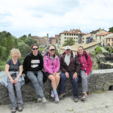 group of pilgrims posing by bridge