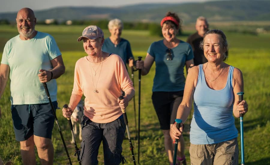 Old family walking the camino with walking poles