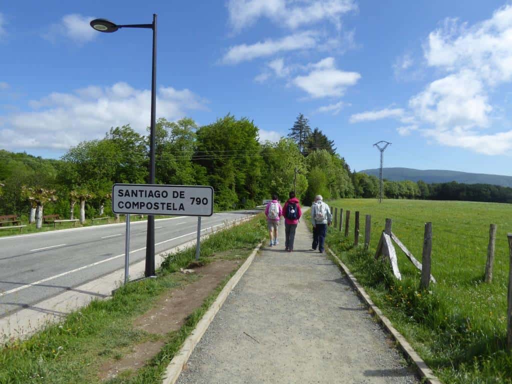 Pilgrims walking along a clean Camino path