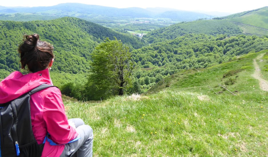 Camino frances start, pilgrim sitting by pyranees mountain range