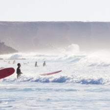 People surfing on beach