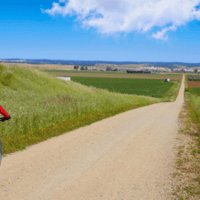 Pilgrim cycling the Camino Frances through hilly region