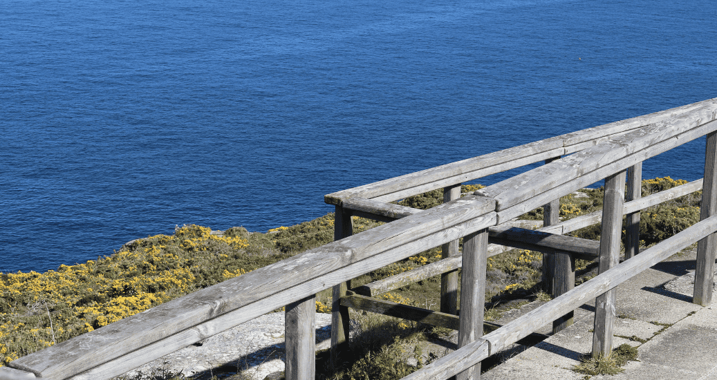 Wooden viewpoint balcony facing the sea on the Costa da Morte Cliffs, on the Camiño dos Faros hiking trail, which connects Malpica with Finisterre in Galicia, Spain