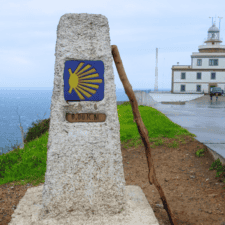 Finisterre Lighthouse with a Camino sign in stone
