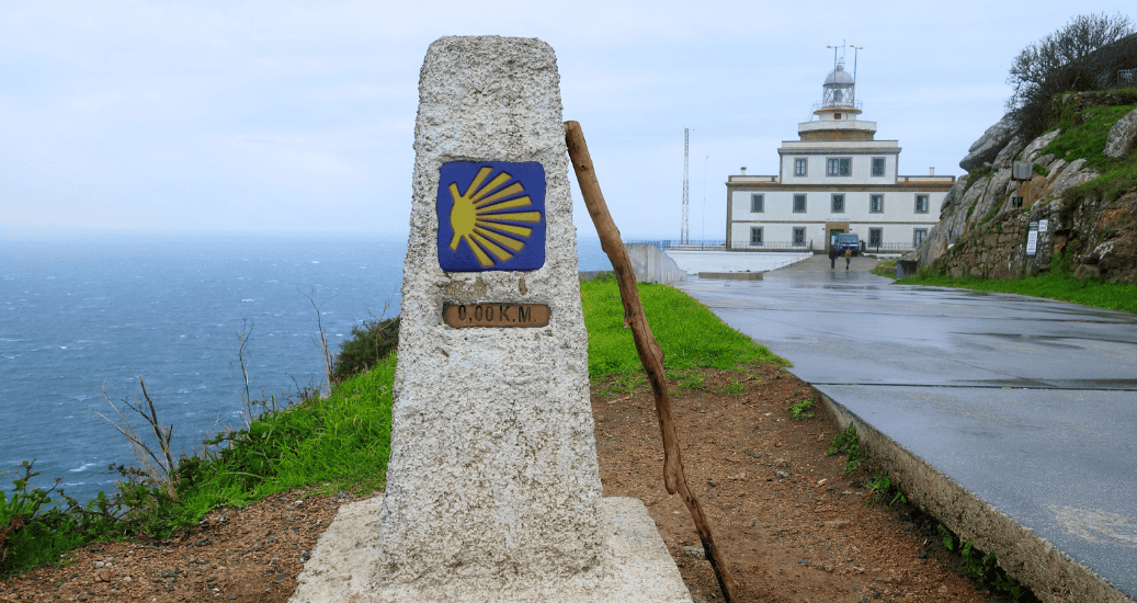 Finisterre Lighthouse with a Camino sign in stone