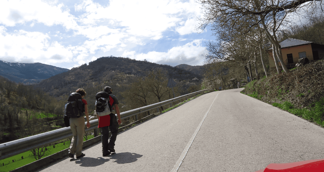 Pilgrims walking through mountain valley
