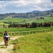 two pilgrims cycling through hilly region on the Via francigena