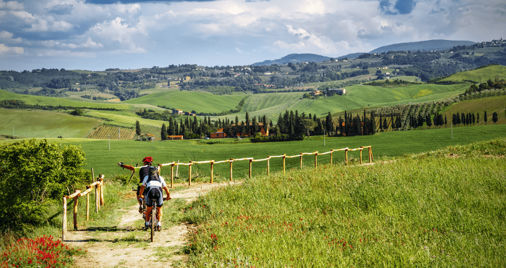 two pilgrims cycling through hilly region on the Via francigena