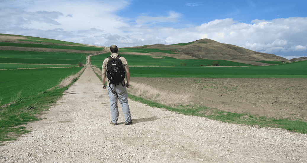 Pilgrim posing on green fields