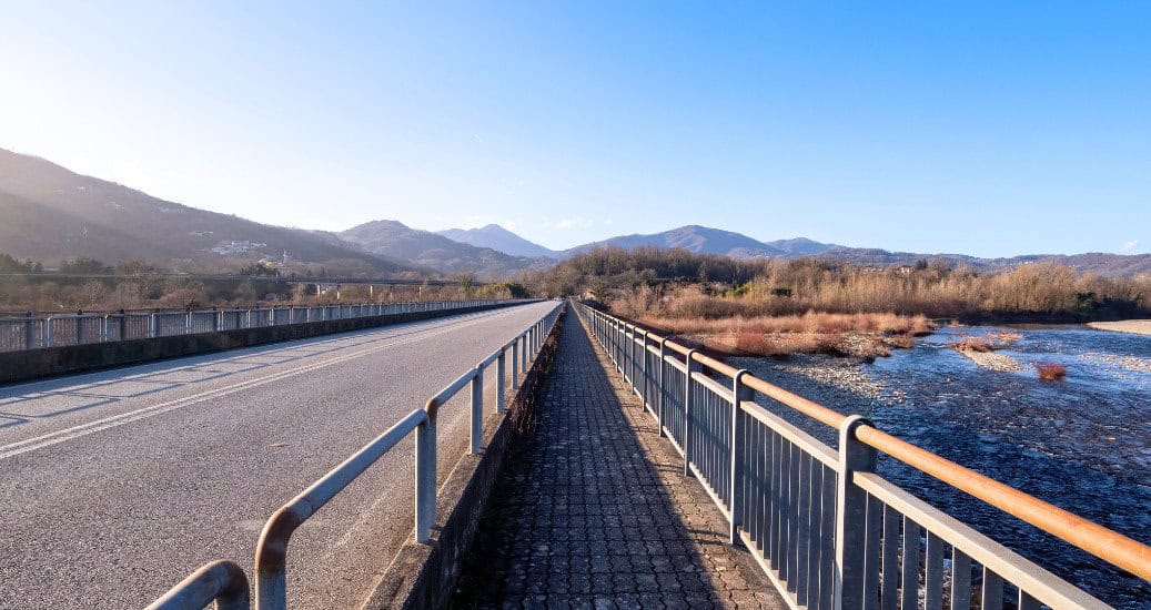 Vanishing Point on Bridge over Magra River in Lunigiana, near Aulla. Winter Landscape. North Tuscany