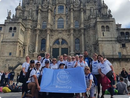 Group of people from cry foundation posing by the cathedral de santiago