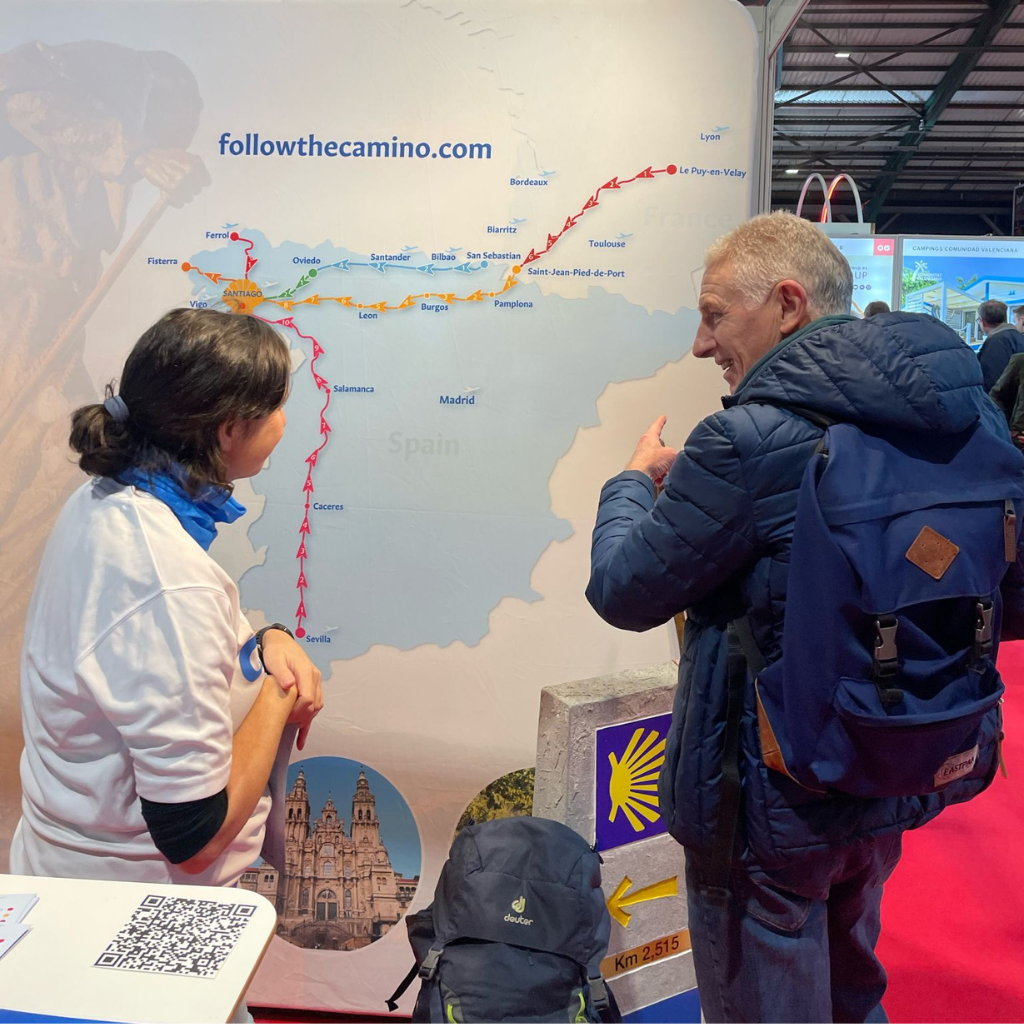 Follow the camino employee explaining client about different camino routes