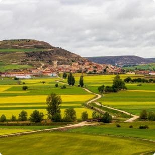 Scenic Castrojeriz springtime view on the Way of St. James, Camino de Santiago in Castile and Leon, Spain under overcast May sky