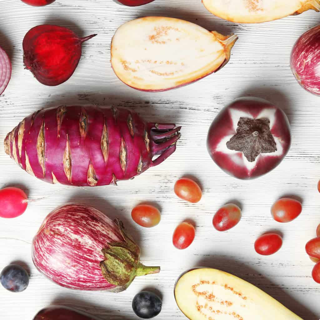 A selection of vegetarian food options, including eggplants and tomatoes
