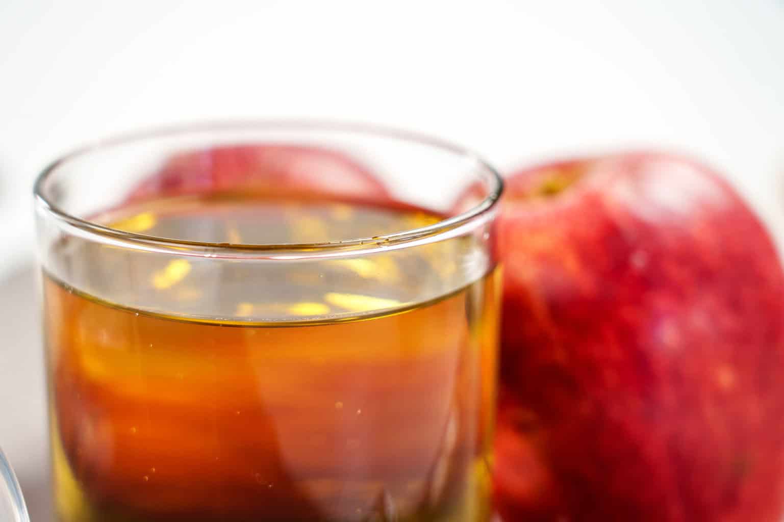 Asturian apple cider and a red apple