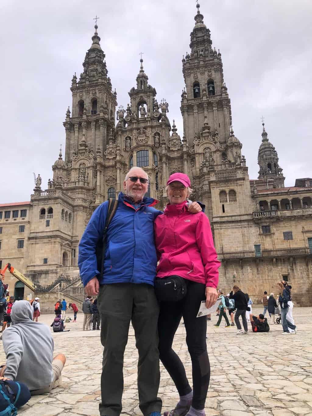 Deirdre Fitzgerald, a client, and her husband outside the Cathedral in Santiago de Compostela after walking the Camino